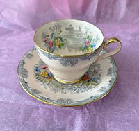 Teacup on saucer showing pattern and gold trim