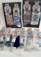 All nine pairs shown packaged; two Complices double-packs above, five single pairs below