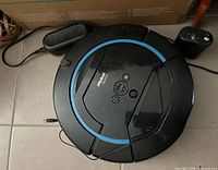 Top view of iRobot Scooba with charger and Virtual Wall