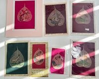 Overall lot showing six Bodhi leaf paintings on various coloured backings