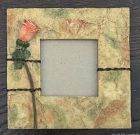 Front view of square frame with rose and wire accents