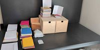 Stacks of multicolor envelopes, cards and wood box on shelf