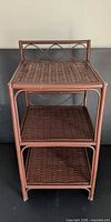 Front view of brown wicker 3-tier shelf