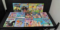 All 14 Robert Munsch paperback books laid out in two rows