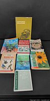 Eight paperback field guides laid out showing front covers