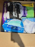 Box contents showing North Aire PM pack, green pack, blue pack 18-count and loose underpads