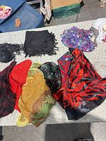 Top view of 8 assorted scarves showing colors and patterns
