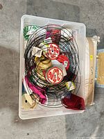 Top view of contents inside plastic box showing ribbon spools and wire frames