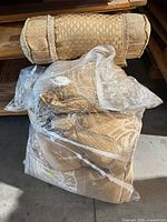 bolster pillow atop compressed bag containing two pillows