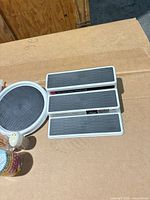 Lot overview showing Copco lazy Susan, three shelf organizers, cupcake liners, toothpick dispenser