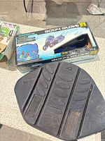 Body Glove fins box with fins visible plus black seat cushion pad