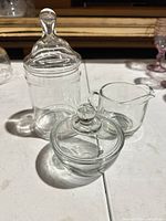 Apothecary jar, lidded bowl and creamer grouped