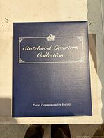 Front cover of blue Statehood Quarters Collection binder