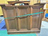 Front view of console showing three paneled doors