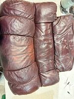 three burgundy leather cushion sections viewed from above
