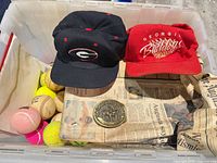 Overview of lot showing two caps, multiple balls, belt buckle