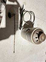 Overview showing brass snuffer, hummingbird holder, ceramic candle jar