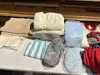 Table view showing towels, diaper packs, pouch, beanie, sweatshirts