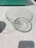 Clear glass footed coupe on table