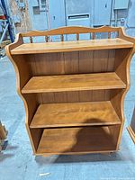 Front view showing three shelves and curved sides