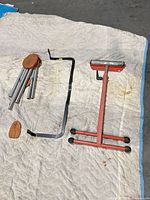 Wind chime, bracket and roller stand laid out on blanket