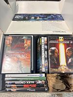 Overall view showing multiple DVD cases, Highlander 2, Skyfall, Snitch, Star Trek VHS box set and P90X fitness box