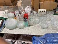 Overall lot showing glass dinnerware, drinking glasses, YETI tumbler and accessories