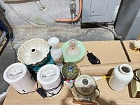 Group showing ceramic mold, vases, green glass stand, USB fans, teapot, decorative egg