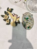 Painted metal/resin wall plaque and oval stained glass panel