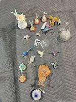 Overall view of mixed figurines, ornaments and charms on blanket