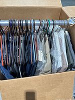 Box with approx. 15 men’s garments on hangers