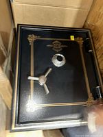 Front view of safe door showing brand emblem, trim, handle and dial