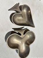 Both pewter dishes side by side showing club and spade shapes