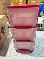 Front view showing three drawers and caster bases