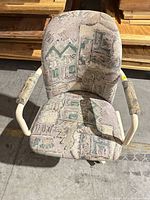 Front view of chair showing pastel geometric fabric, armrests, seat and back