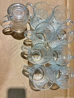 Top view showing nine clear crystal pitchers stacked, illustrating quantity and design
