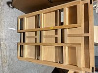 Stacked maple frames showing light finish and metal brackets