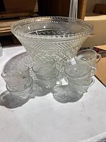 Punch bowl with stacked handled cups