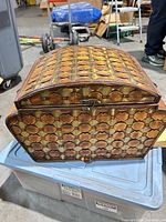 Front view of chest showing carved pattern and latch