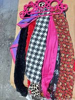 Eight assorted scarves on pink multi-loop hanger