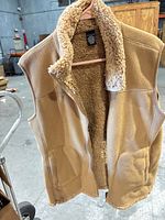 Front view of tan fleece vest with sherpa lining