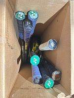 Top view into box showing six racket handles with Yonex logo end caps