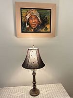 Lamp displayed on table below artwork showing full view