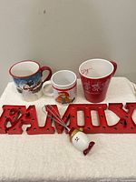 Full lot overview: three mugs, FAMILY sign, whisk