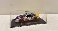 Front-left view of 1:43 die-cast NASCAR #40 car in acrylic case