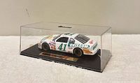 Front-left view of die-cast NASCAR #41 model in display case