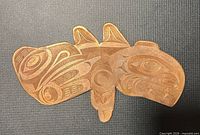 Front view of entire copper plaque showing engraved eagle and orca design
