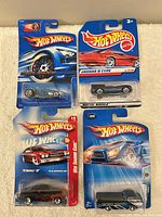 Overview of four carded Hot Wheels cars