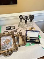 overview of lot with bottles, frames, spoons, shakers, scissors