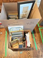 Two boxes filled with assorted picture frames